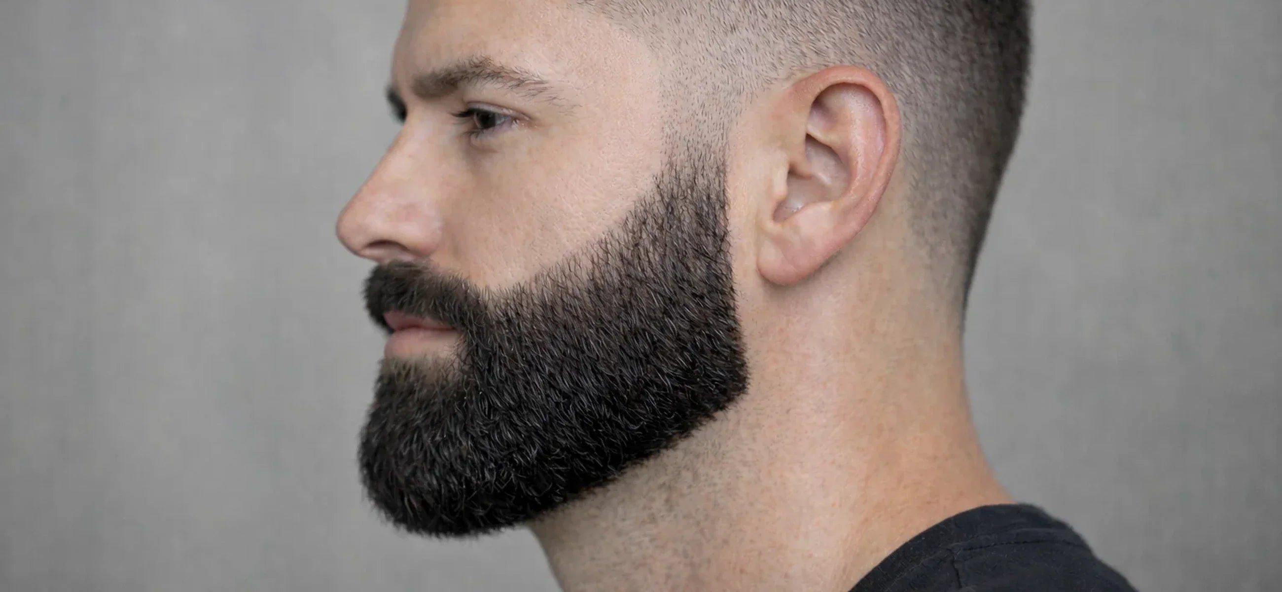 Full beard with defined cheek and neck lines and a connected mustache