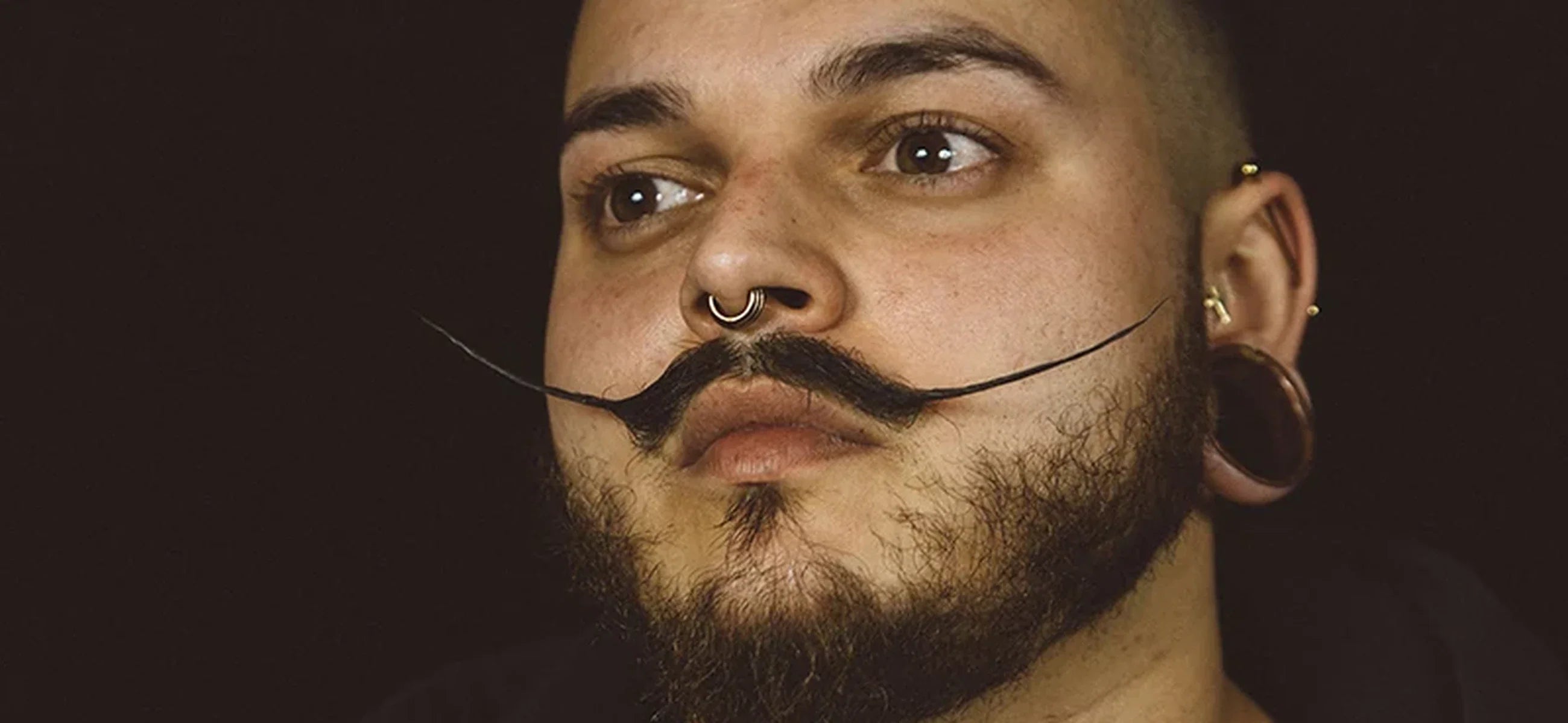 Dalí-inspired pointed mustache paired with a beard