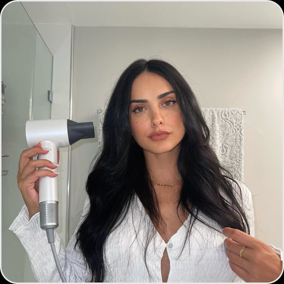 A woman is taking care of her hair in the shower