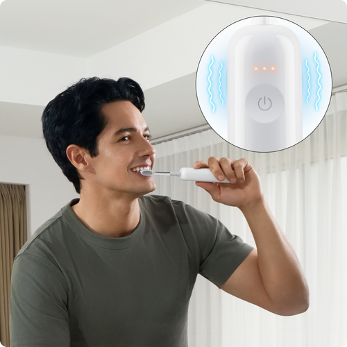 Person brushing teeth in front of a smart mirror with a digital display.