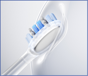 Close-up of a white electric toothbrush with blue bristle heads on a light gray background